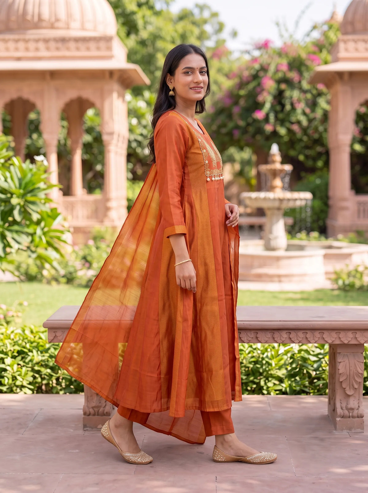 RUST ORANGE ANARKALI SUIT FEATURING GOLD EMBROIDERED YOKE WITH TASSELS