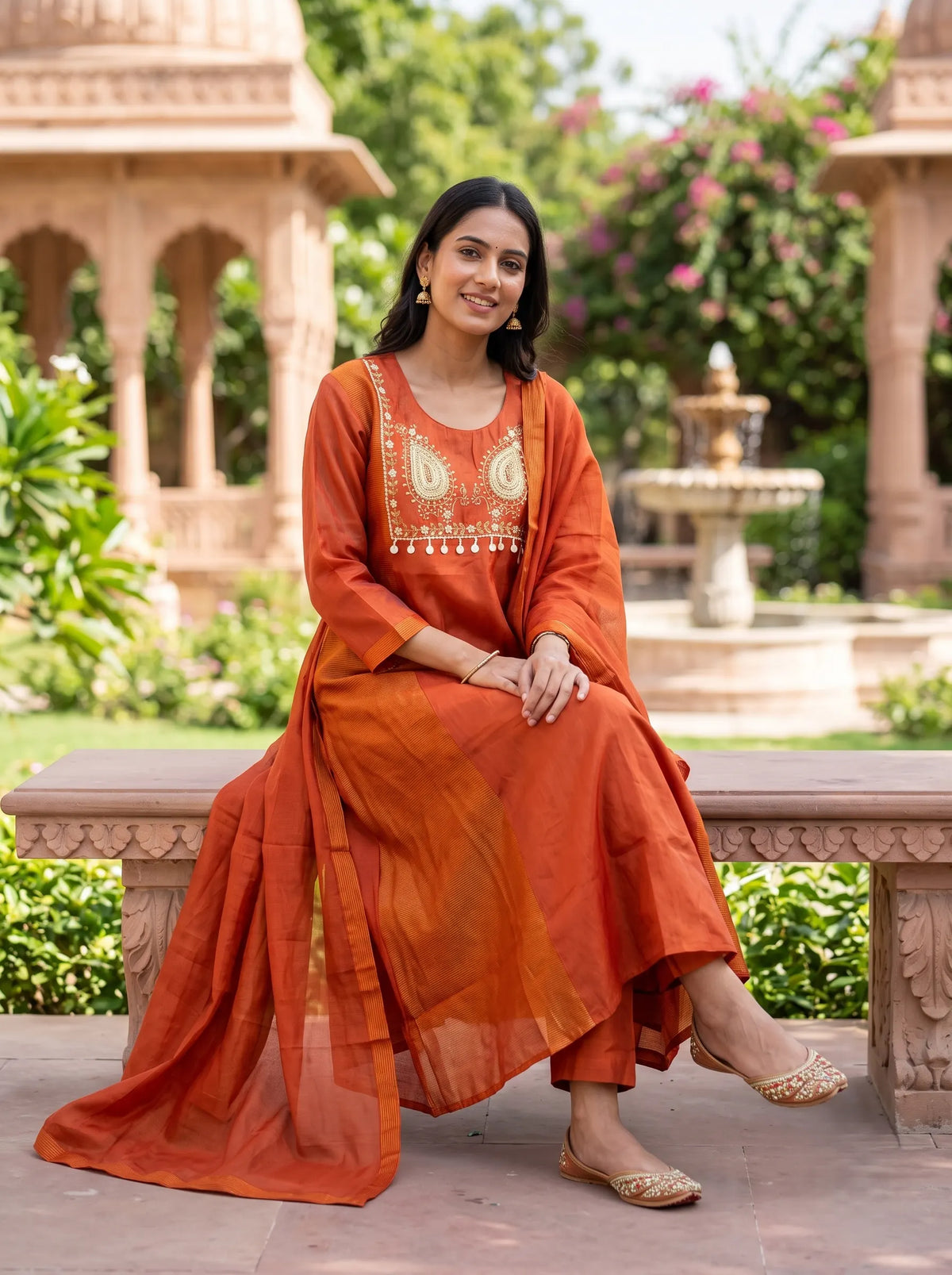 RUST ORANGE ANARKALI SUIT FEATURING GOLD EMBROIDERED YOKE WITH TASSELS