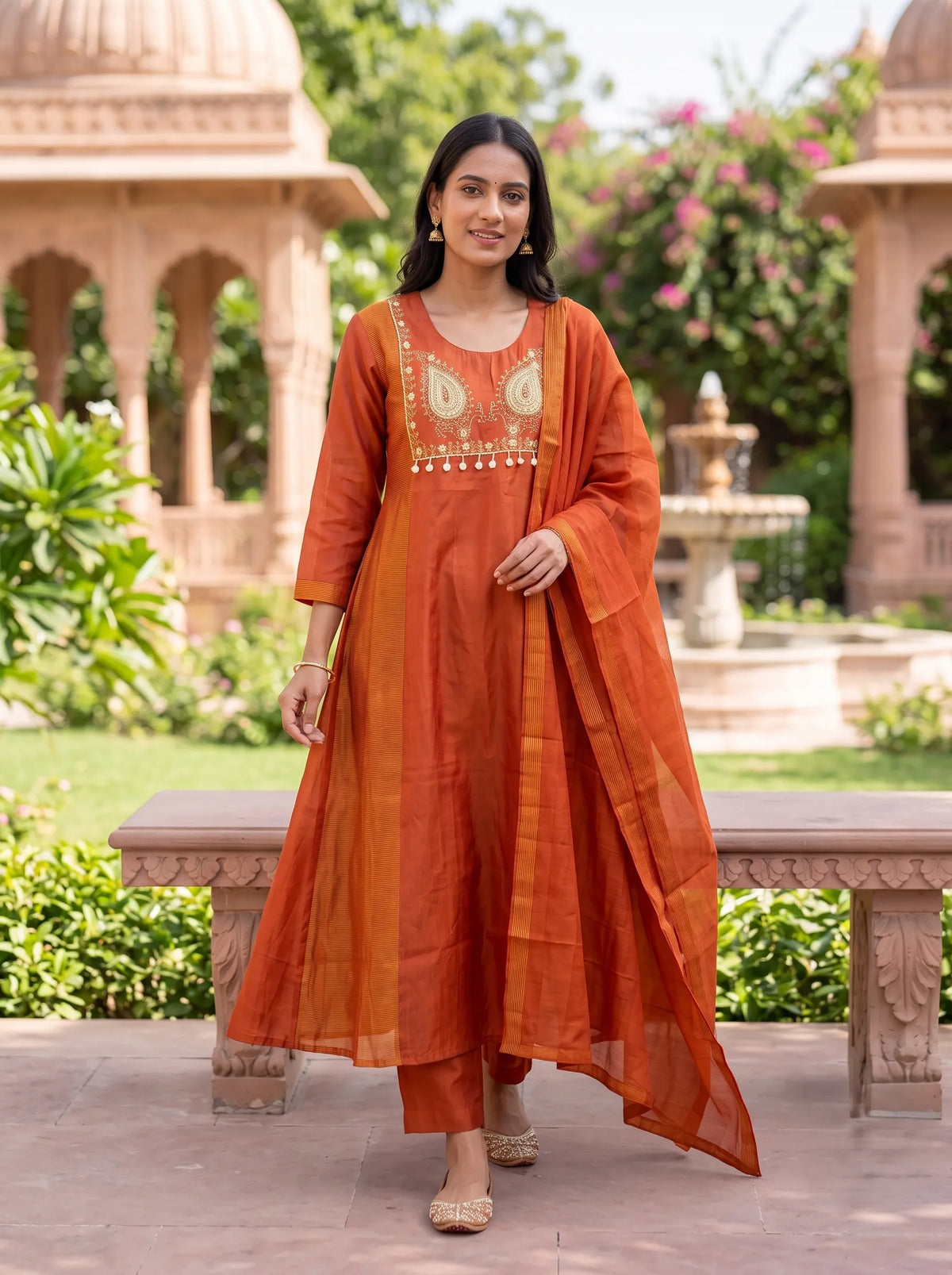 RUST ORANGE ANARKALI SUIT FEATURING GOLD EMBROIDERED YOKE WITH TASSELS