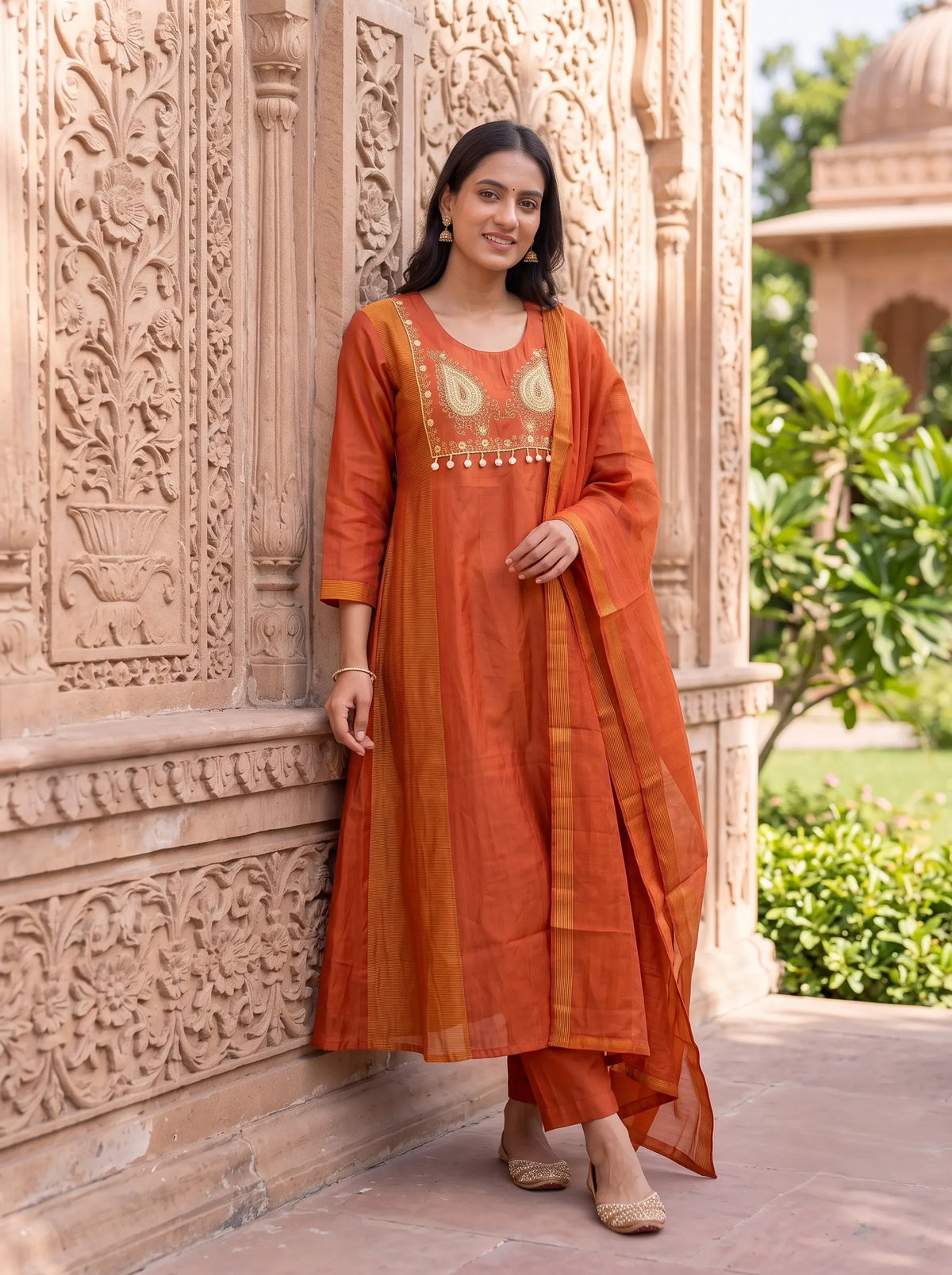 RUST ORANGE ANARKALI SUIT FEATURING GOLD EMBROIDERED YOKE WITH TASSELS